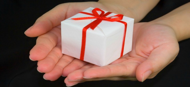 Mother's Day - wrapped present with red bow held in two hands