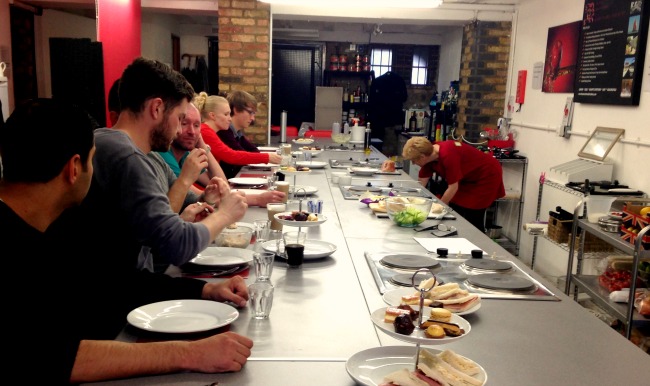 Everyone sitting down to enjoy their afternoon tea with a twist at the cookery school.