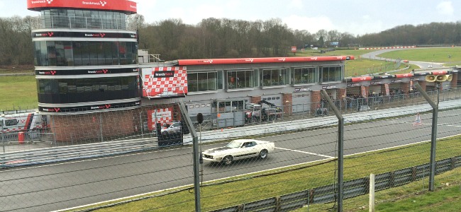 A snapshot view of a classic mustang racing around the track